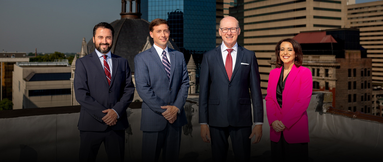 Group photo of the Mehr Fairbanks Trial Lawyers and the Lexington skyline in the background